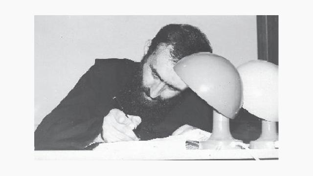 În chilia sa, la masa de scris